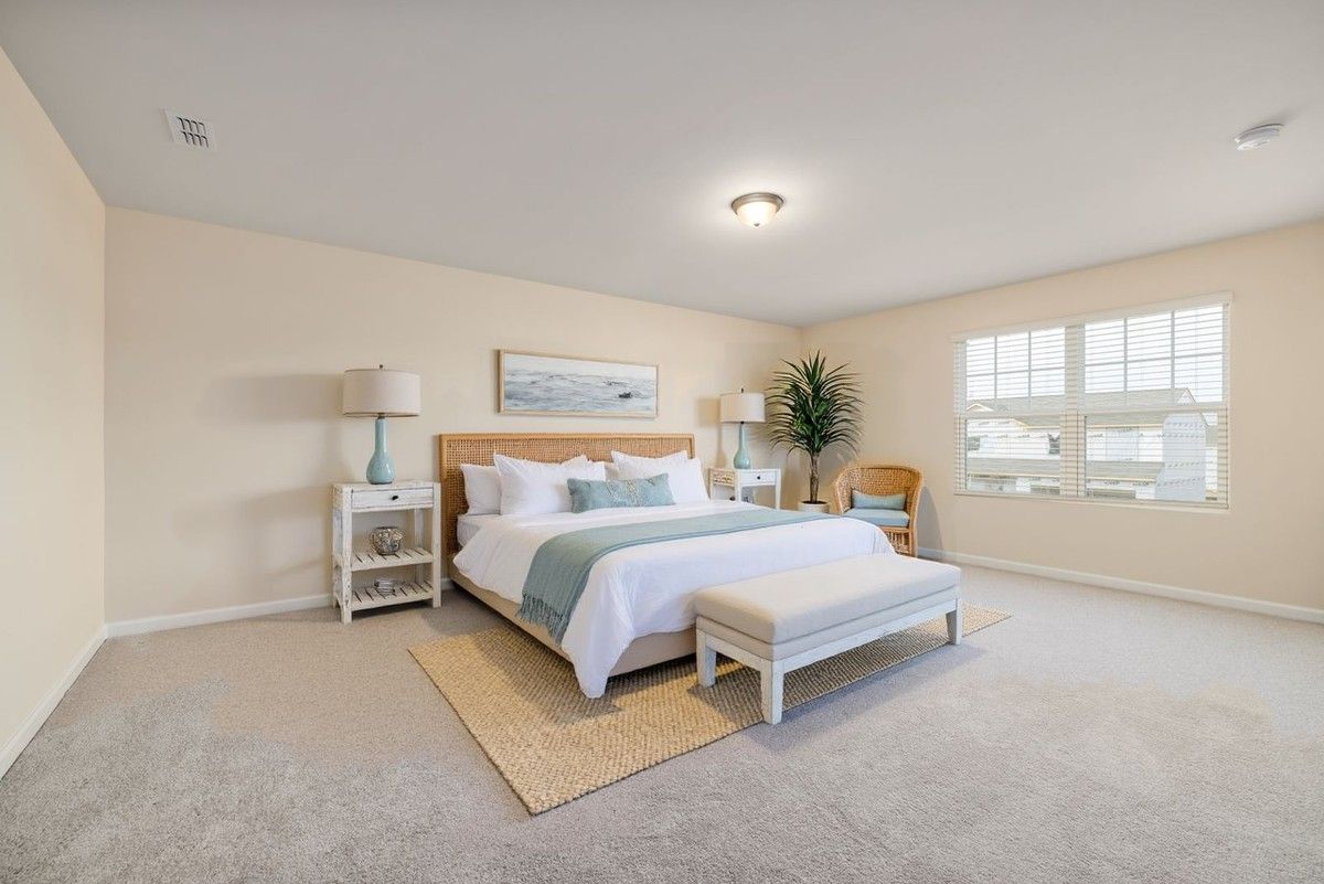 Virtually staged: the same bedroom with digitally added furniture; walls, windows, fixtures and floor unchanged
